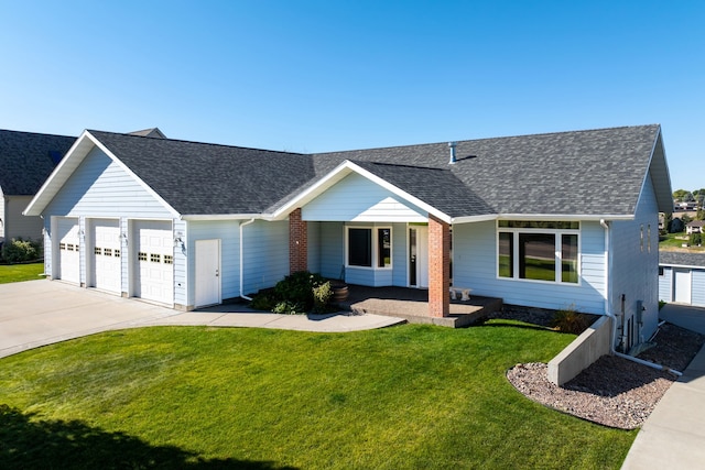 ranch-style house featuring a garage and a front lawn