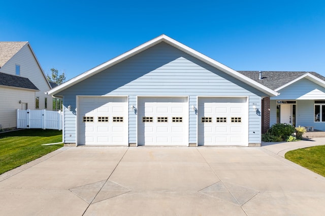 ranch-style home featuring a front yard and a garage