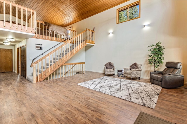 155 Grandview Ln, Seeley Lake, MT 59868 - living area with wooden ceiling, wood-type flooring, a high ceiling, stairs, and baseboards