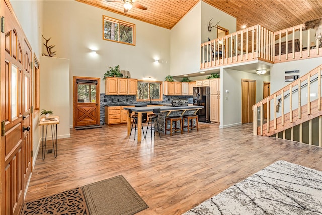 155 Grandview Ln, Seeley Lake, MT 59868 - dining area featuring high vaulted ceiling, wood ceiling, baseboards, light wood-style floors, and stairs