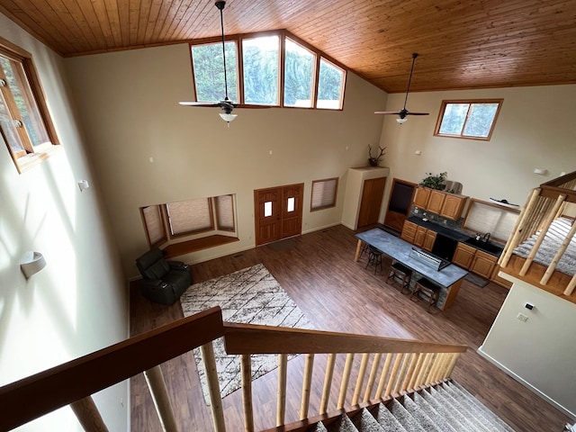 living room with lofted ceiling, a wealth of natural light, wood-type flooring, and wooden ceiling