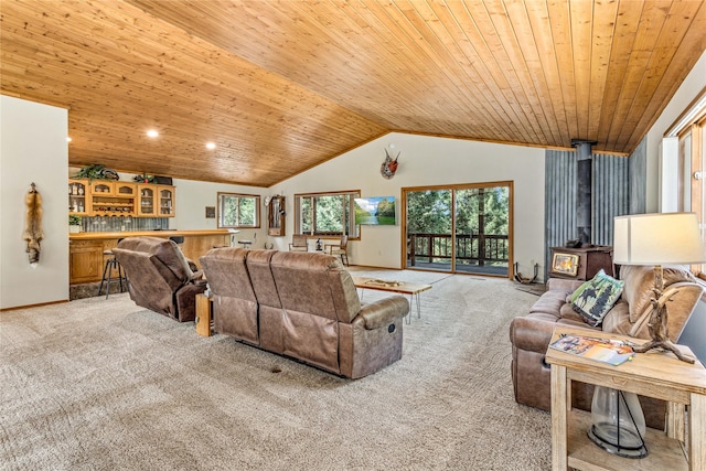 155 Grandview Ln, Seeley Lake, MT 59868 - living room featuring a wood stove, light carpet, wood ceiling, vaulted ceiling, and a dry bar