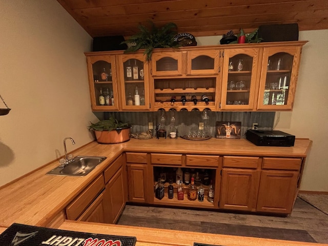 bar featuring wood ceiling, lofted ceiling, and sink