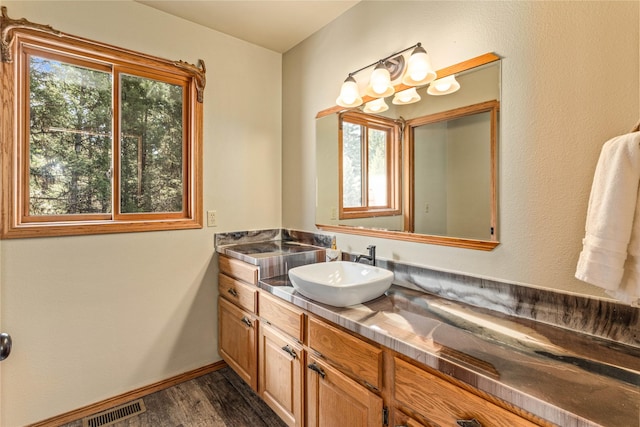 155 Grandview Ln, Seeley Lake, MT 59868 - bathroom featuring wood finished floors, vanity, and baseboards