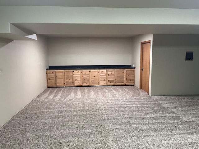 basement featuring light colored carpet