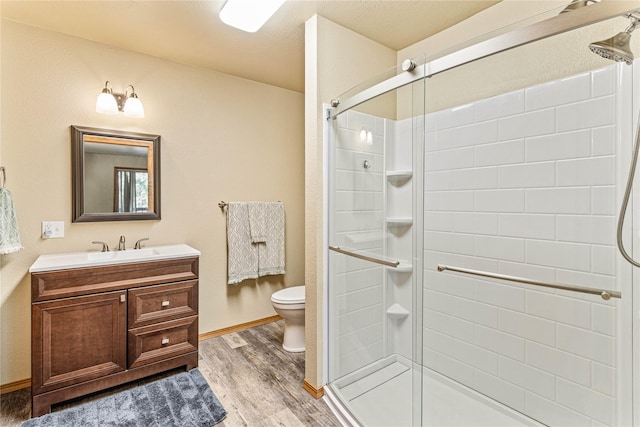 155 Grandview Ln, Seeley Lake, MT 59868 - full bath with wood finished floors, toilet, a stall shower, and vanity