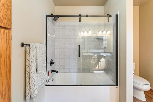 155 Grandview Ln, Seeley Lake, MT 59868 - bathroom featuring toilet, enclosed tub / shower combo, and wood finished floors