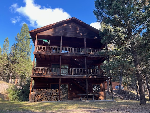 rear view of property featuring a wooden deck