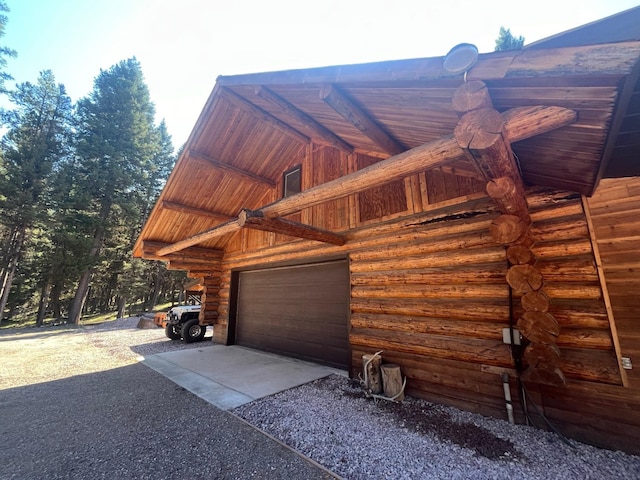 view of home's exterior with a garage and an outbuilding