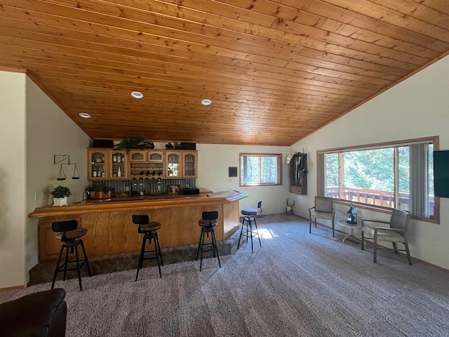 bar featuring lofted ceiling, dark carpet, and wood ceiling