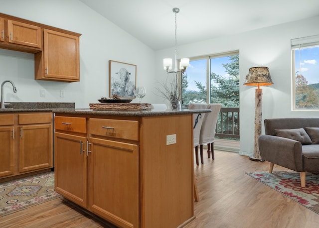 kitchen with light hardwood / wood-style flooring, lofted ceiling, and a healthy amount of sunlight