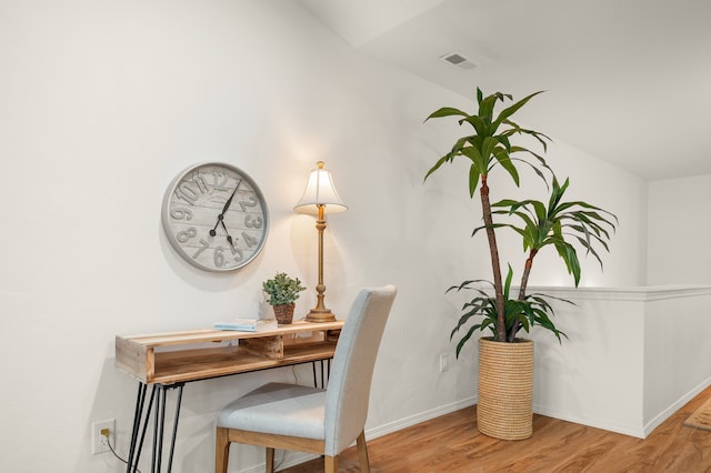 interior space with hardwood / wood-style flooring and vaulted ceiling