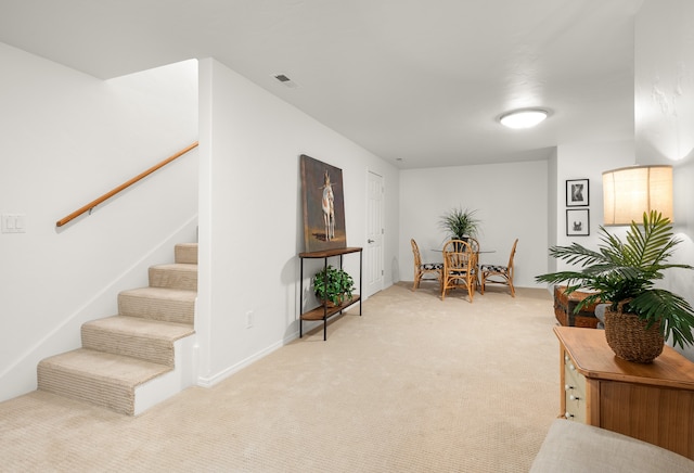 living area with light carpet