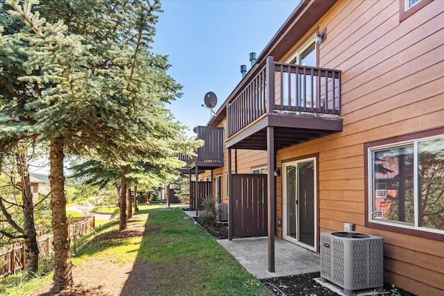 view of yard with a balcony and central air condition unit