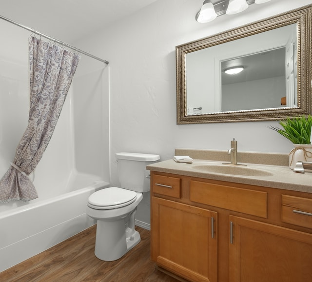 full bathroom featuring wood-type flooring, vanity, toilet, and shower / bath combination with curtain