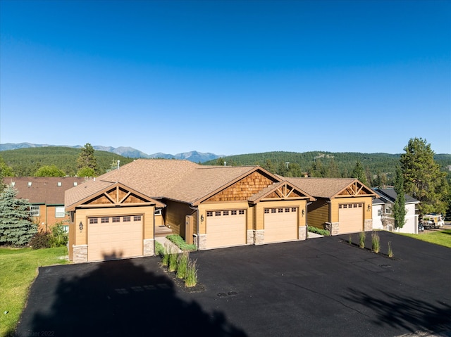 view of front facade with a mountain view and a garage