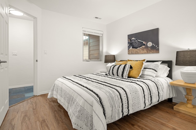 bedroom with hardwood / wood-style flooring