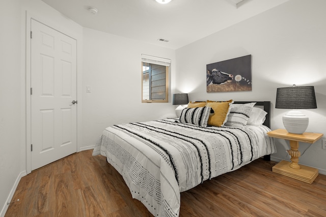 bedroom with hardwood / wood-style floors