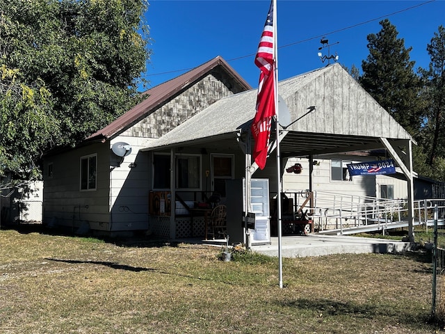 view of front of house with a front yard and a carport