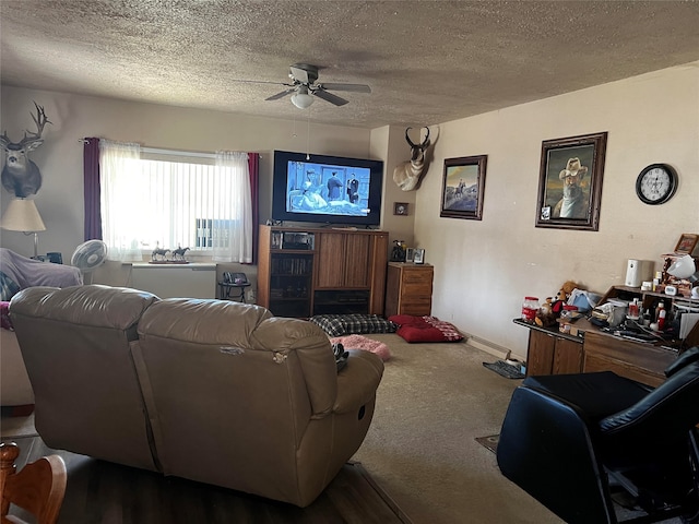 living room featuring a textured ceiling, carpet, and ceiling fan