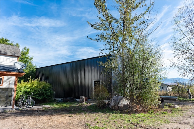 view of side of home featuring an outbuilding