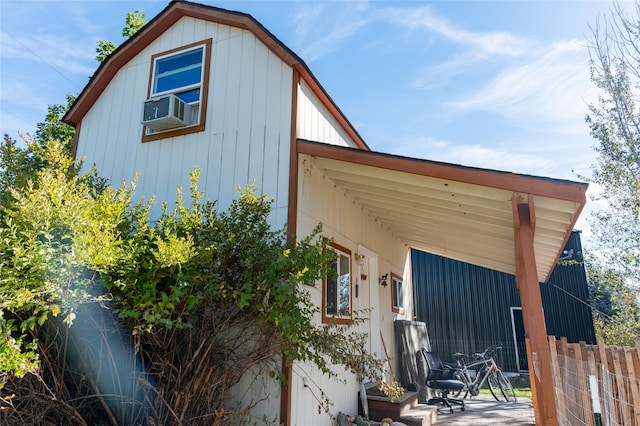 view of property exterior with cooling unit and fence