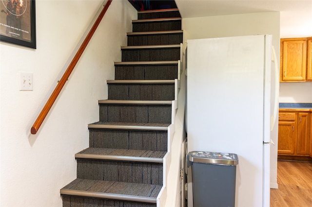 stairway with wood finished floors