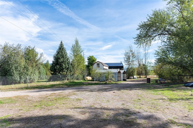 view of yard featuring fence and an outdoor structure