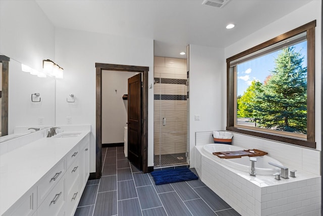 bathroom featuring plus walk in shower and vanity