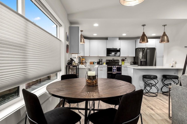 1010 7th St E Unit A, Whitefish, MT 59937 - dining space with light wood finished floors, recessed lighting, and vaulted ceiling