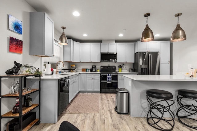 1010 7th St E Unit A, Whitefish, MT 59937 - kitchen featuring double oven range, stainless steel fridge, a sink, black dishwasher, and light wood-style floors