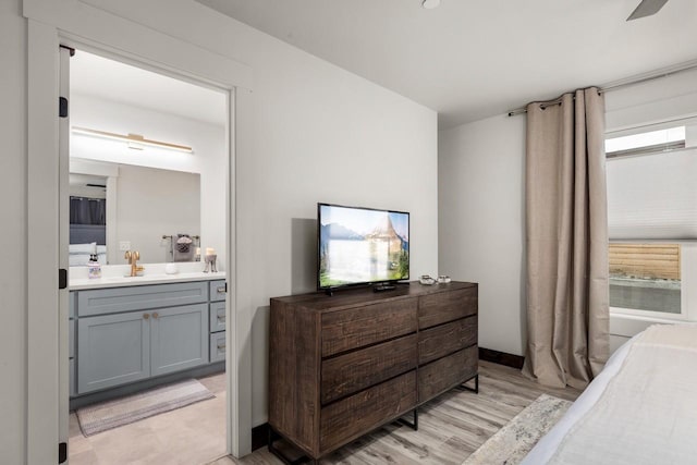 1010 7th St E Unit A, Whitefish, MT 59937 - bedroom with a sink, light wood-style floors, and ensuite bathroom