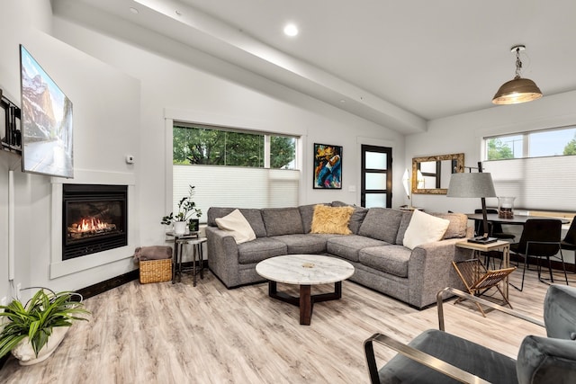 living room with light hardwood / wood-style flooring and lofted ceiling