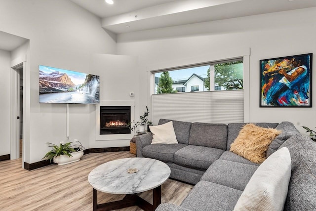 1010 7th St E Unit A, Whitefish, MT 59937 - living area featuring wood finished floors, a glass covered fireplace, baseboards, and recessed lighting