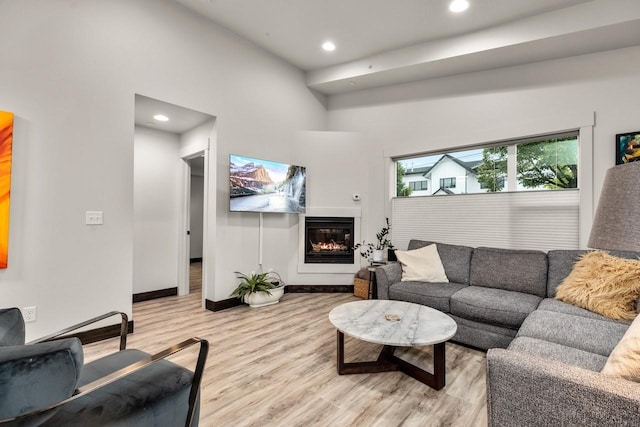 1010 7th St E Unit A, Whitefish, MT 59937 - living area with light wood finished floors, recessed lighting, a glass covered fireplace, and baseboards