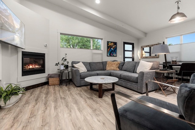 1010 7th St E Unit A, Whitefish, MT 59937 - living room with lofted ceiling, a glass covered fireplace, light wood-style flooring, and recessed lighting