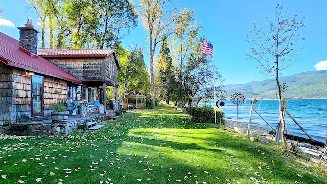 view of yard with a water and mountain view and a gazebo