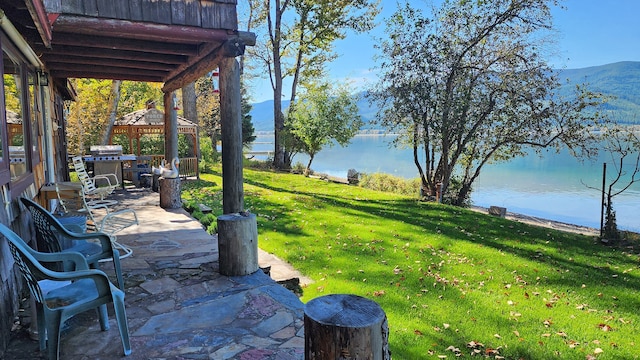 view of yard with a gazebo, a water and mountain view, and a patio area