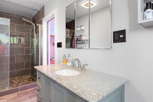 bathroom with walk in shower and vanity