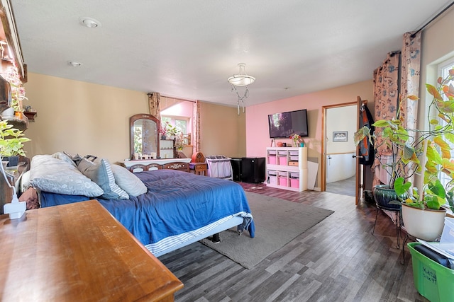 bedroom with dark hardwood / wood-style floors