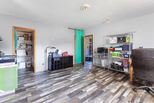 office area with a textured ceiling and dark wood-type flooring