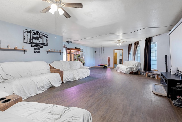 bedroom featuring ceiling fan, a textured ceiling, and dark hardwood / wood-style floors