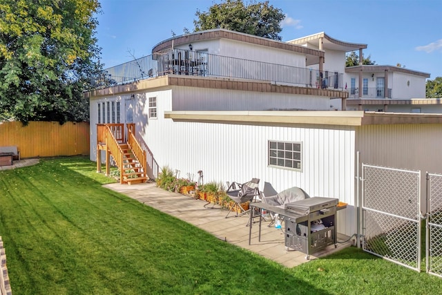 rear view of property with a lawn and a patio area