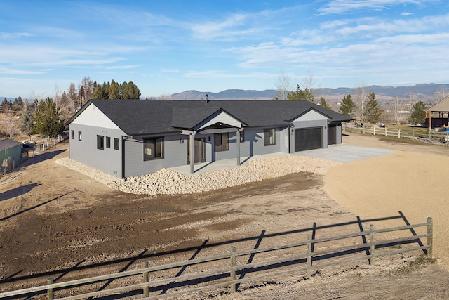 ranch-style house with a mountain view and a garage