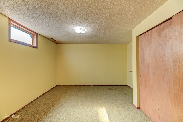 basement featuring a textured ceiling and carpet flooring