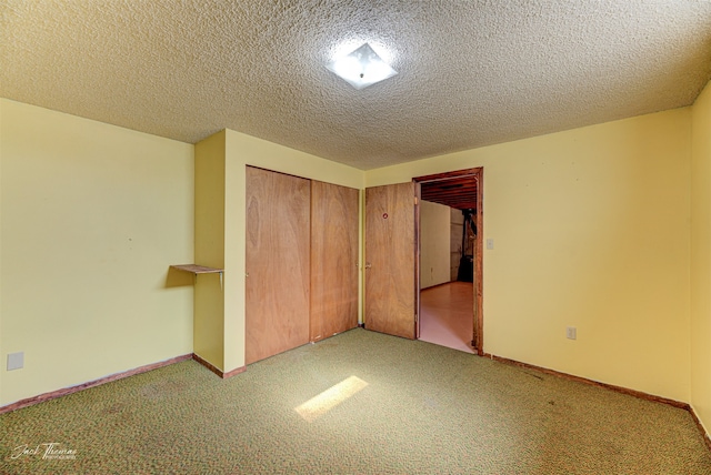 unfurnished bedroom featuring light colored carpet, a textured ceiling, and a closet