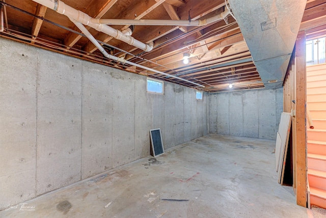 below grade area with a healthy amount of sunlight and stairs