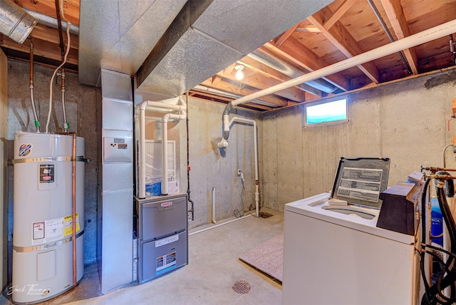 below grade area featuring strapped water heater and washer / dryer
