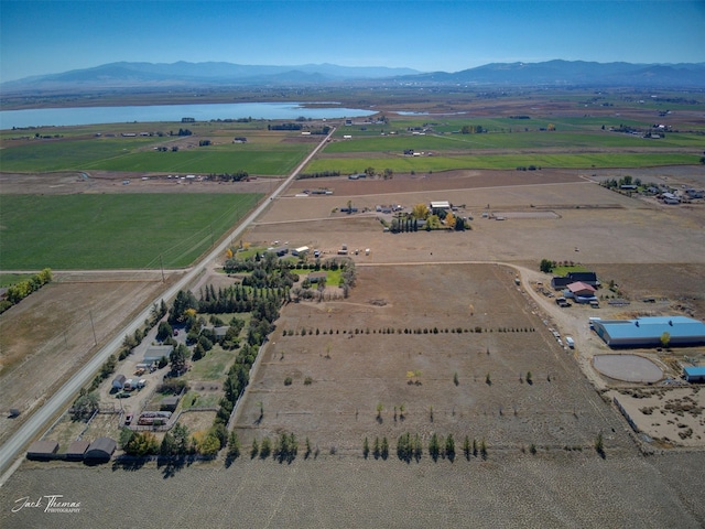 drone / aerial view featuring a rural view and a water and mountain view