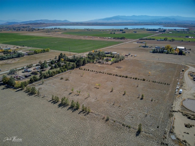birds eye view of property with a rural view and a water and mountain view